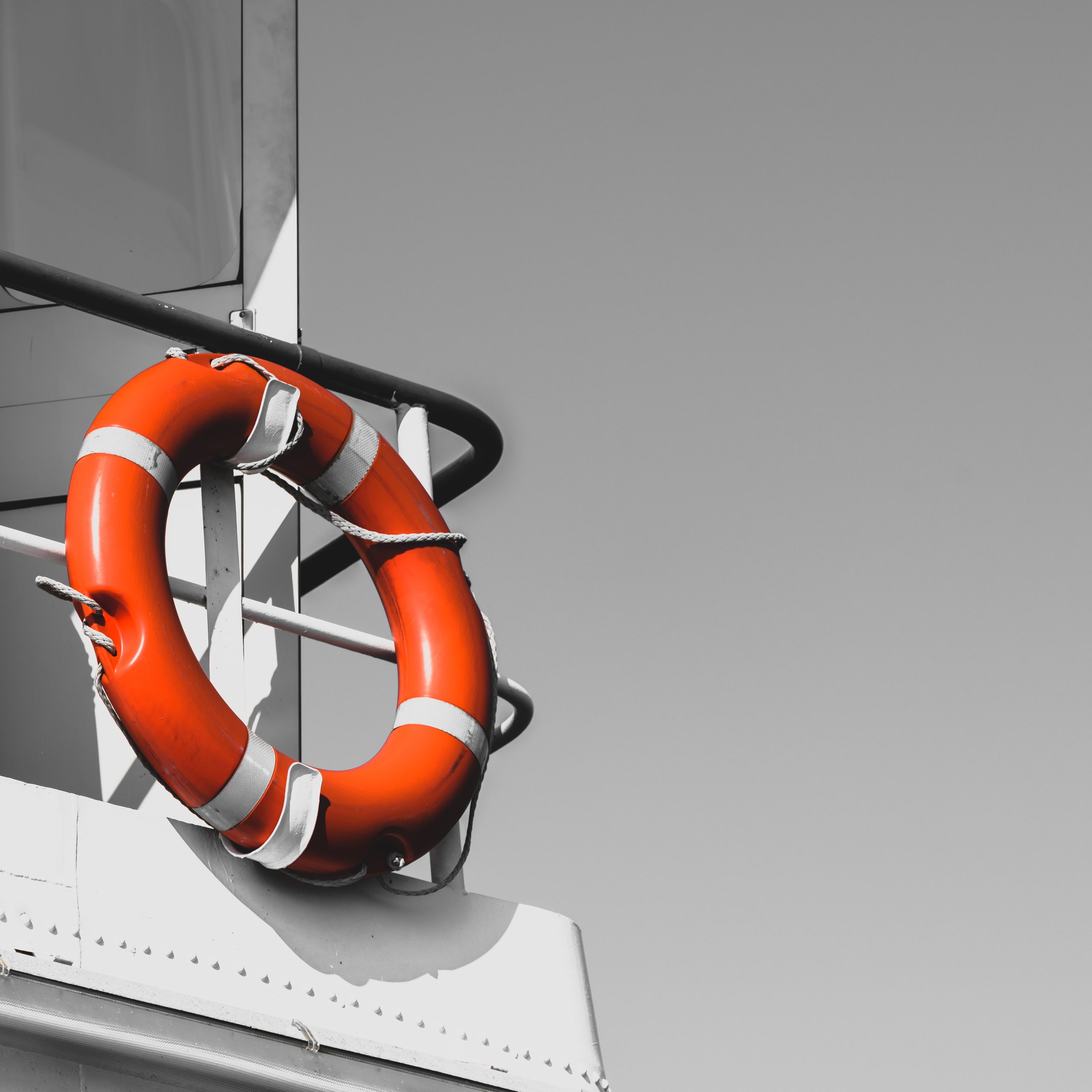 Bright orange lifebuoy on yacht