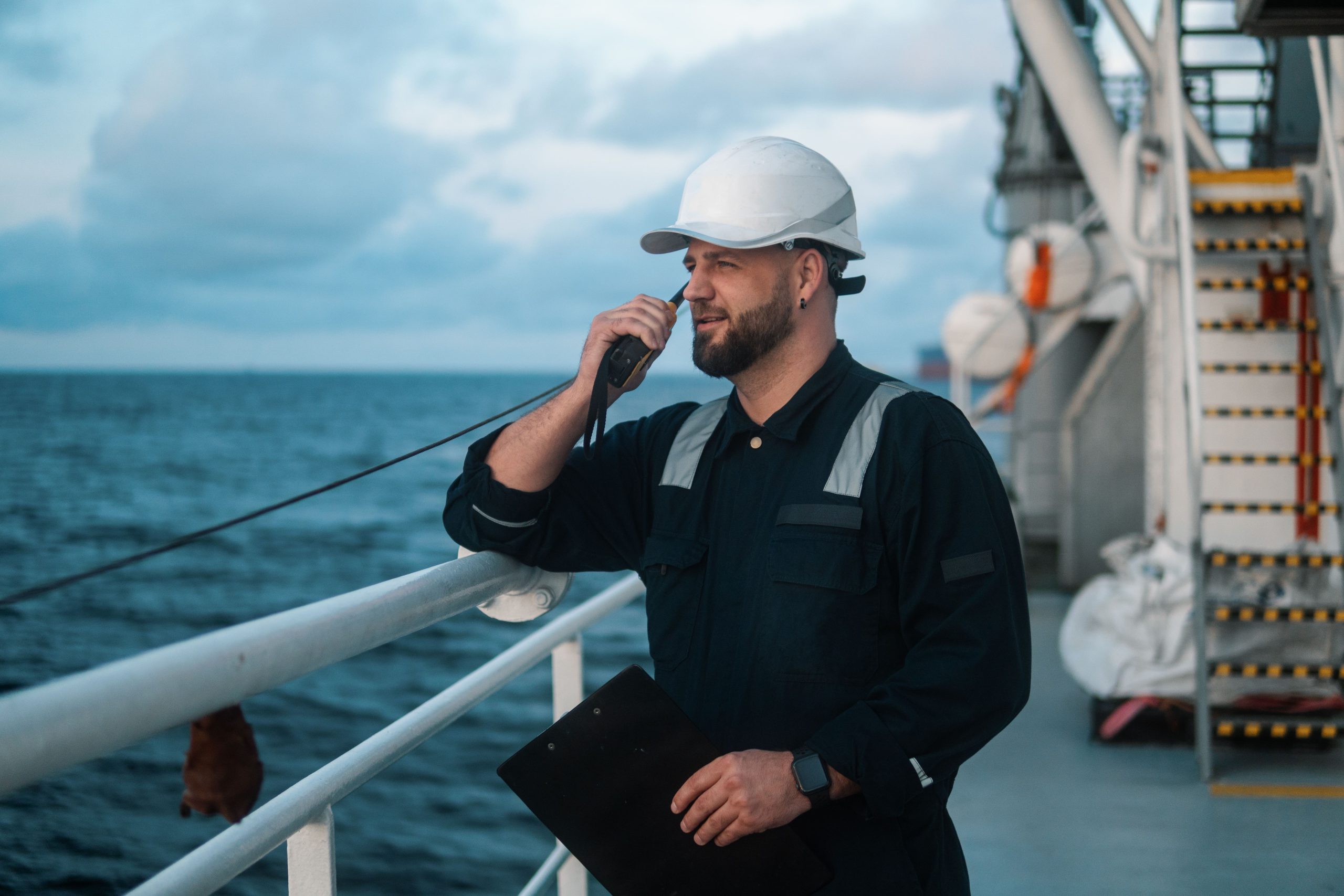 Officer communicating on a ship deck.