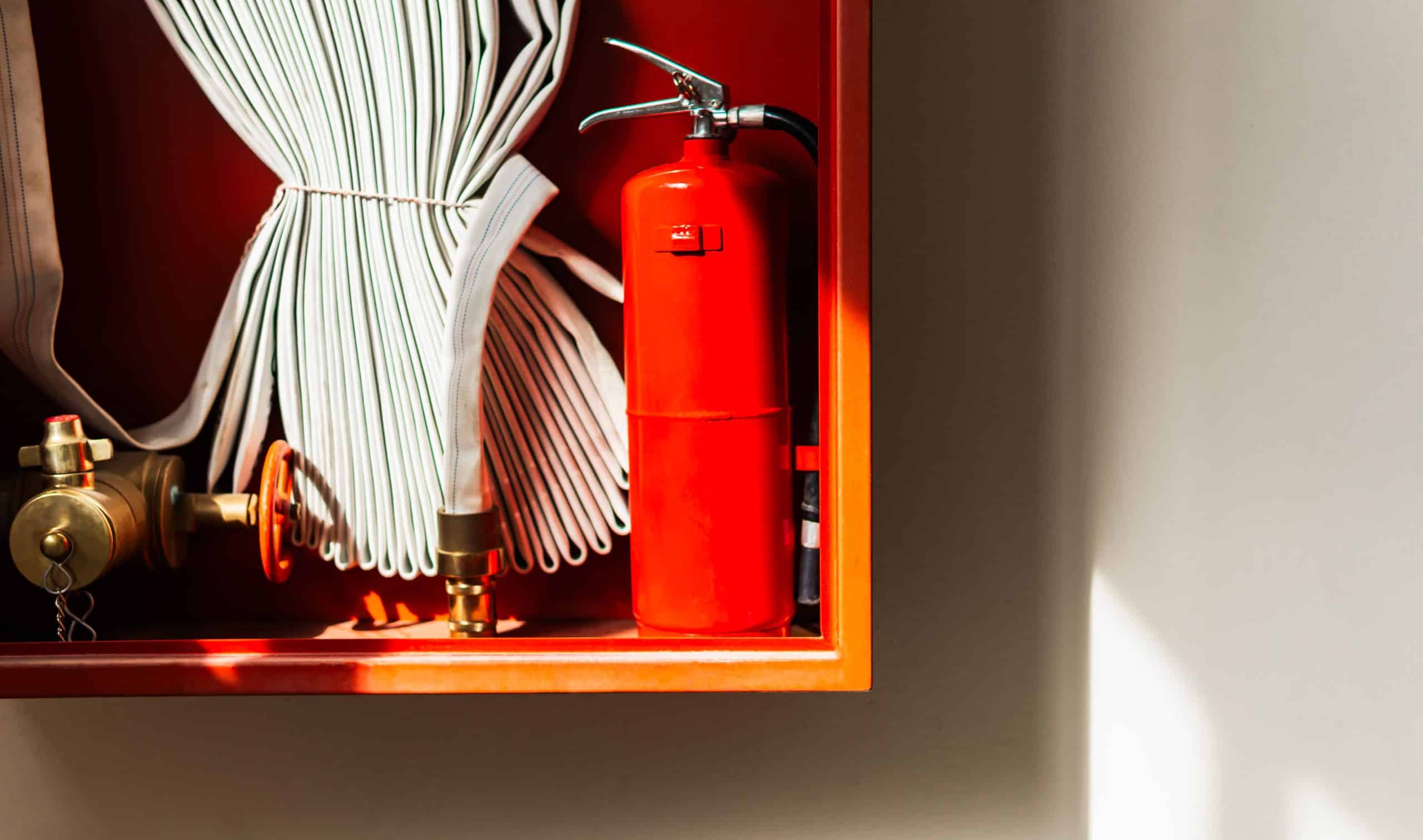 Red fire extinguisher and hoses